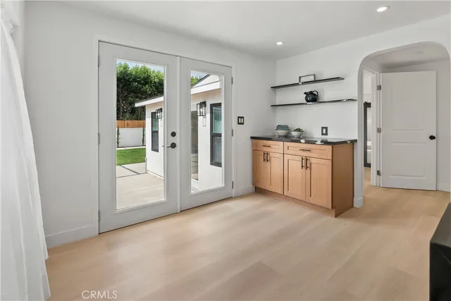 a spacious bedroom with a bed and a chandelier