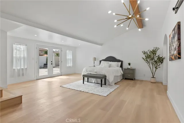 a spacious bedroom with a bed a table and chair