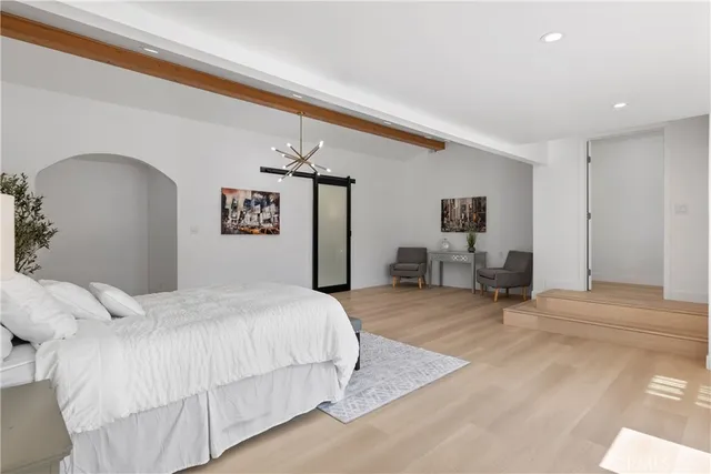 a spacious bedroom with a bed and a window