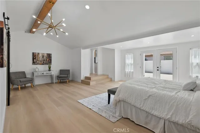 a bedroom with a large bed and painting on the wall