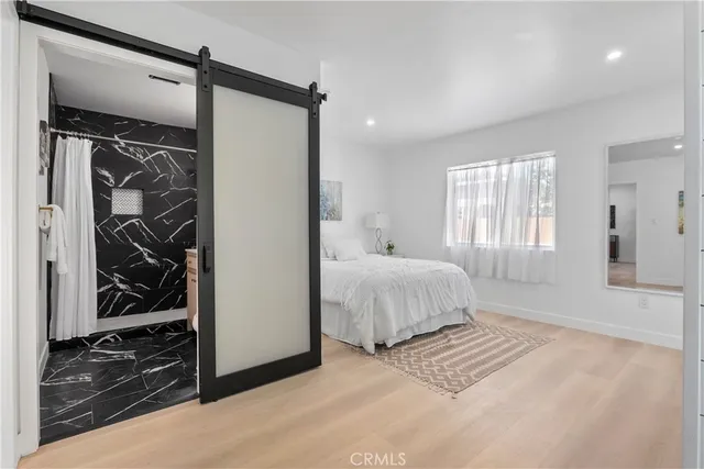 a bedroom with a bed and a chandelier