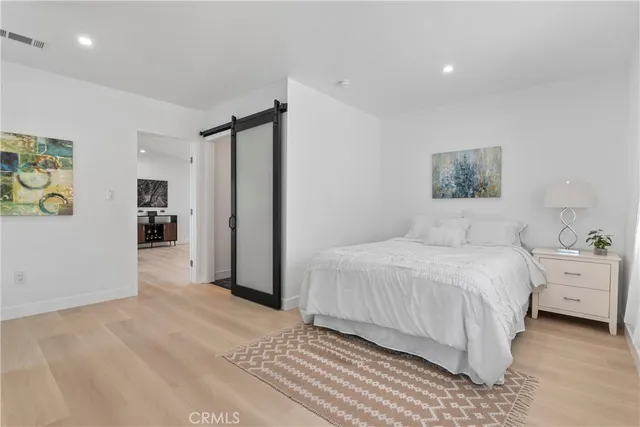 a bedroom with two beds and a lamp