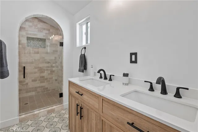 a view of backyard with large tree and a wooden fence