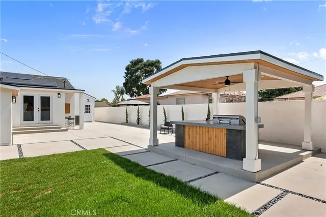a aerial view of a house with a yard and a fountain