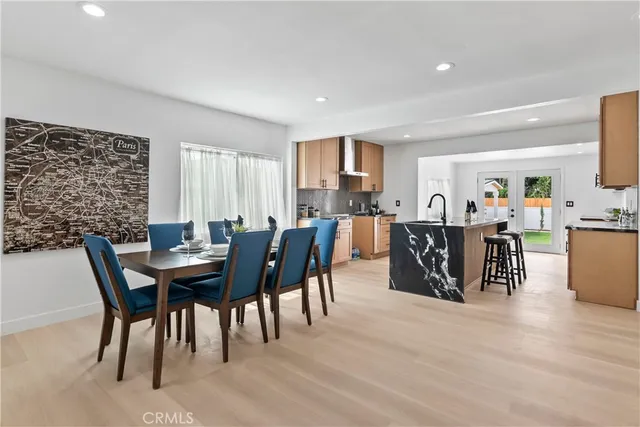 a view of a a dining room with furniture window and wooden floor