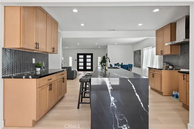 a kitchen with granite countertop a sink and a stove