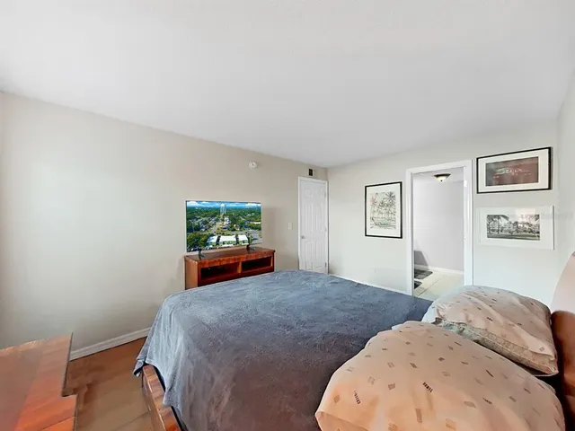 a bedroom with two beds and a painting on the wall