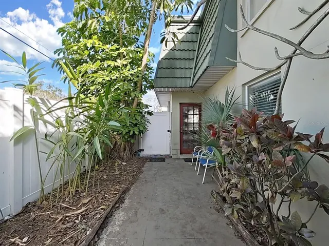 a view of a chairs and table in a backyard