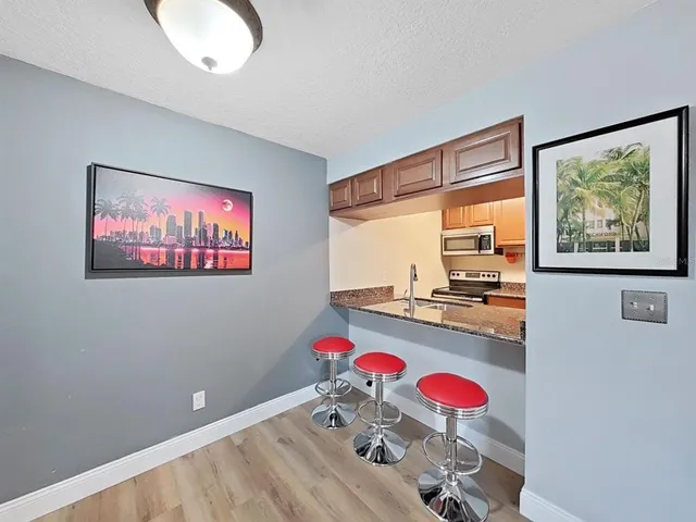 a view of a room with furniture and a flat screen tv