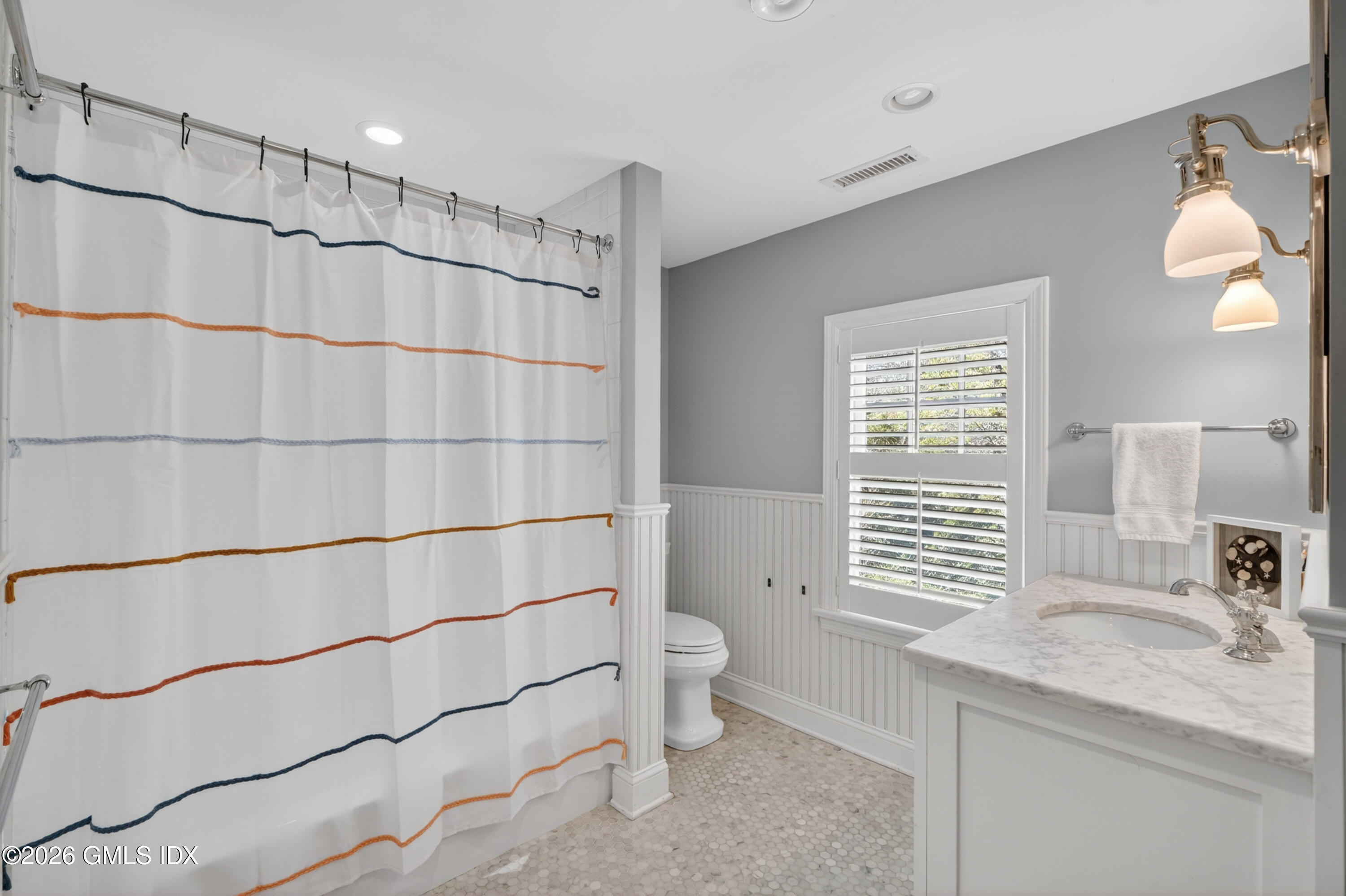 20 Ridge Road Cos Cob, CT 06807 - Photo 30 of 36 a bathroom with a granite countertop sink a toilet a mirror and shower