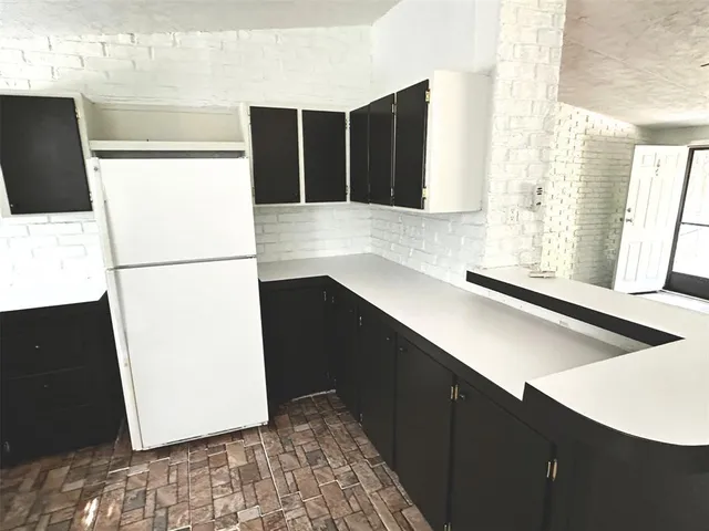 a kitchen with a refrigerator and a stove