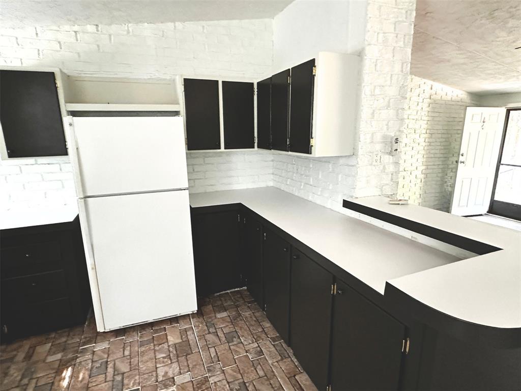 1395 Blackjack Road Valley View, TX 76272 - Photo 5 of 22 a kitchen with a refrigerator and a stove