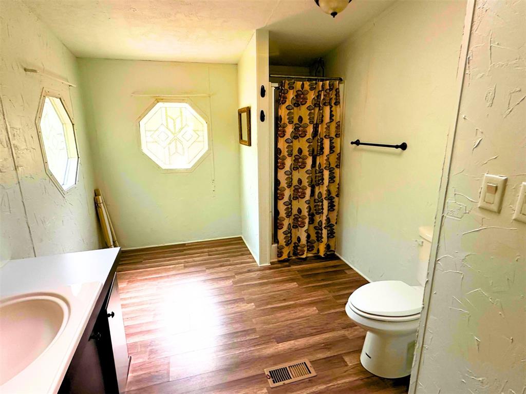 1395 Blackjack Road Valley View, TX 76272 - Photo 9 of 22 a bathroom with a toilet and a shower