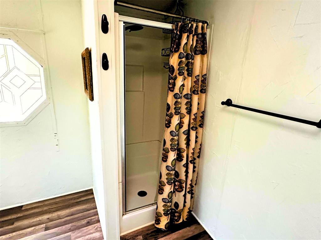 1395 Blackjack Road Valley View, TX 76272 - Photo 10 of 22 a bathroom with a shower and a curtain