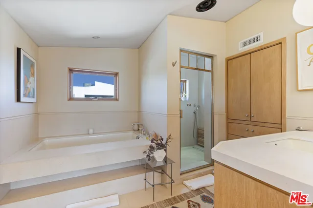 a bathroom with a bathtub and a shower