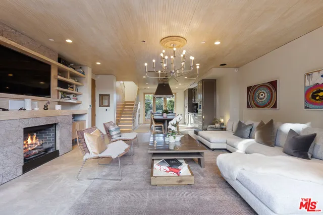 a living room with furniture fireplace and flat screen tv