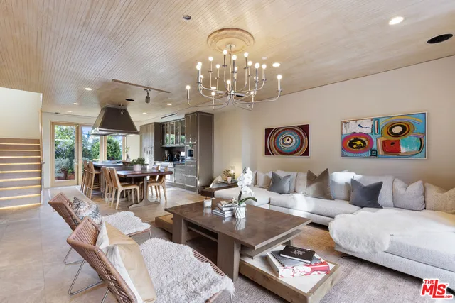 a living room with furniture and a chandelier