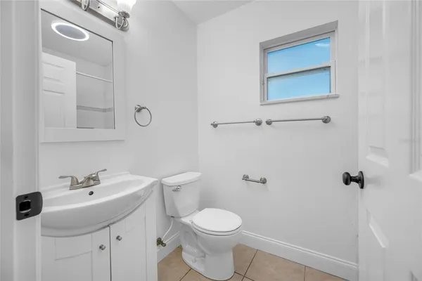 a white toilet sitting next to a bathroom sink