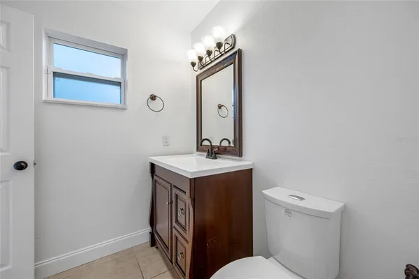 a bathroom with a sink a toilet and mirror