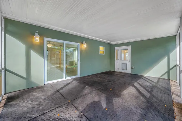 a view of a big room with windows and entryway