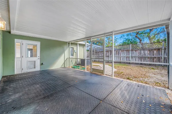 a view of empty room with wooden floor and floor to ceiling window