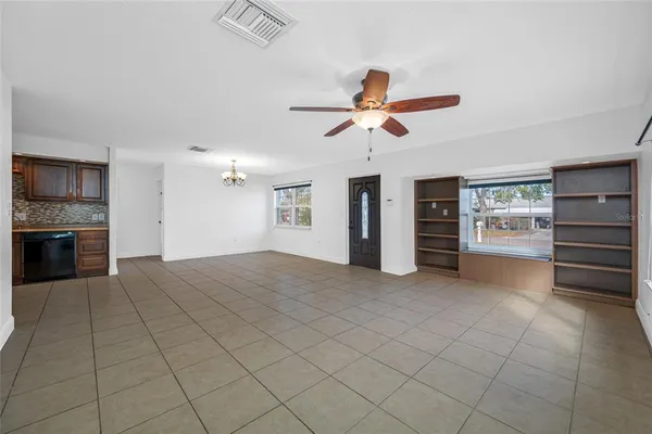 a view of a kitchen with furniture and a ceiling fan