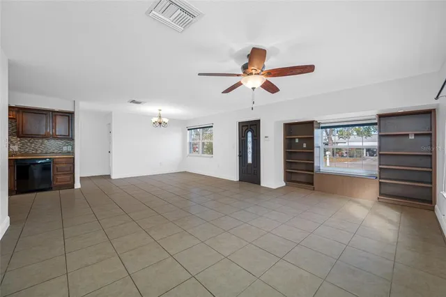a view of a kitchen with furniture and a ceiling fan