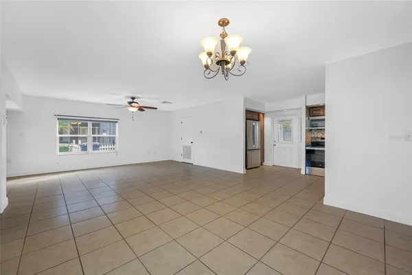 a view of an empty room with a chandelier