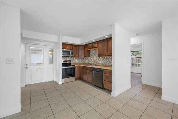 a kitchen with stainless steel appliances granite countertop a refrigerator and a sink
