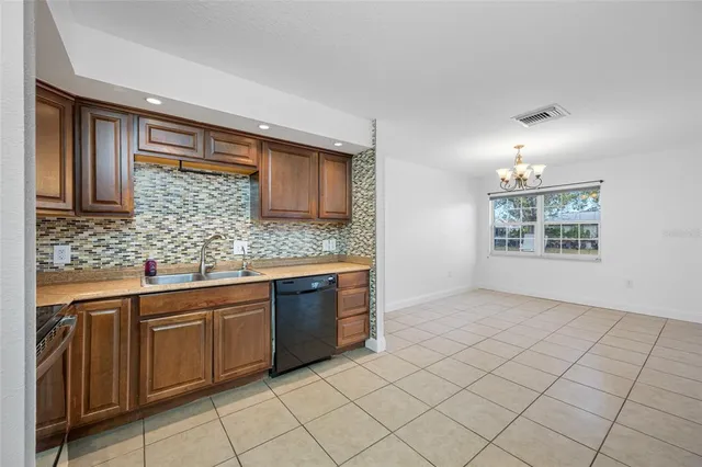 a kitchen with stainless steel appliances granite countertop a sink and cabinets