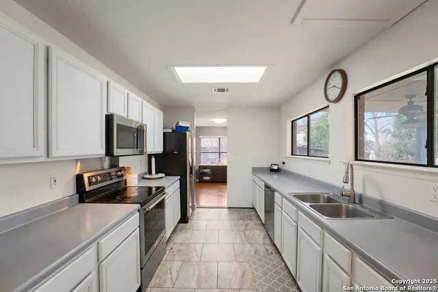 a kitchen with a sink stove and refrigerator