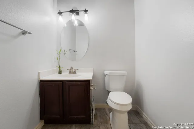 a bathroom with a toilet sink and mirror