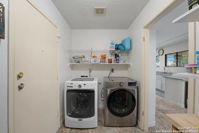 a utility room with sink dryer and washer