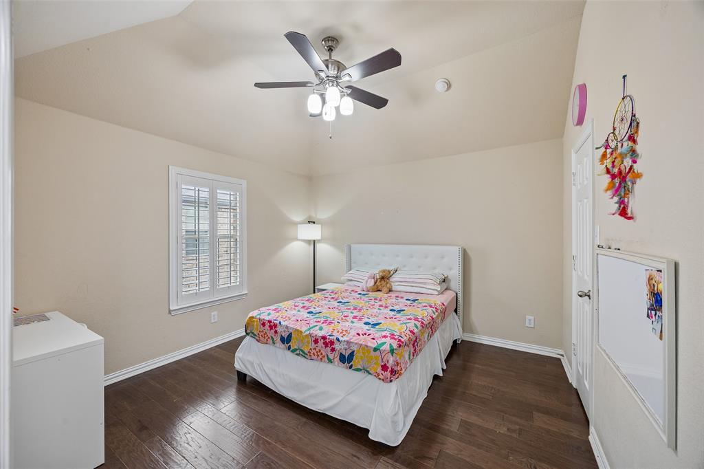 2865 Ridge View Road Frisco, TX 75034 - Photo 31 of 38 Vaulted ceiling with a ceiling fan, wood-finish flooring, white window shutters, and a white door