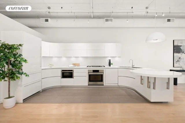 a kitchen with stainless steel appliances a white and white cabinets