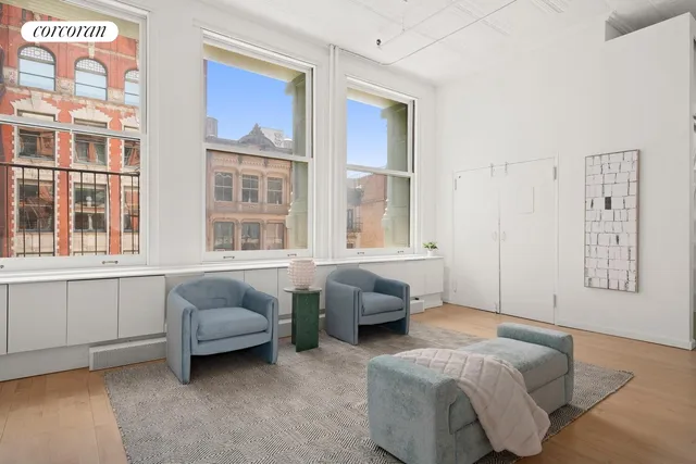 a spacious bedroom with a bed and a window