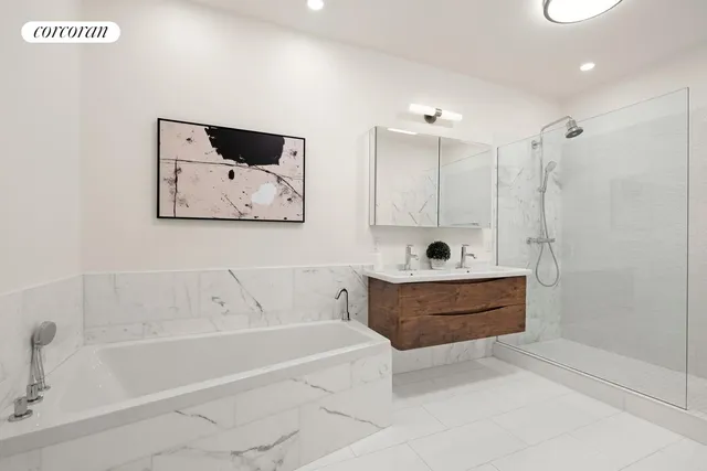 a bathroom with a tub a sink and mirror