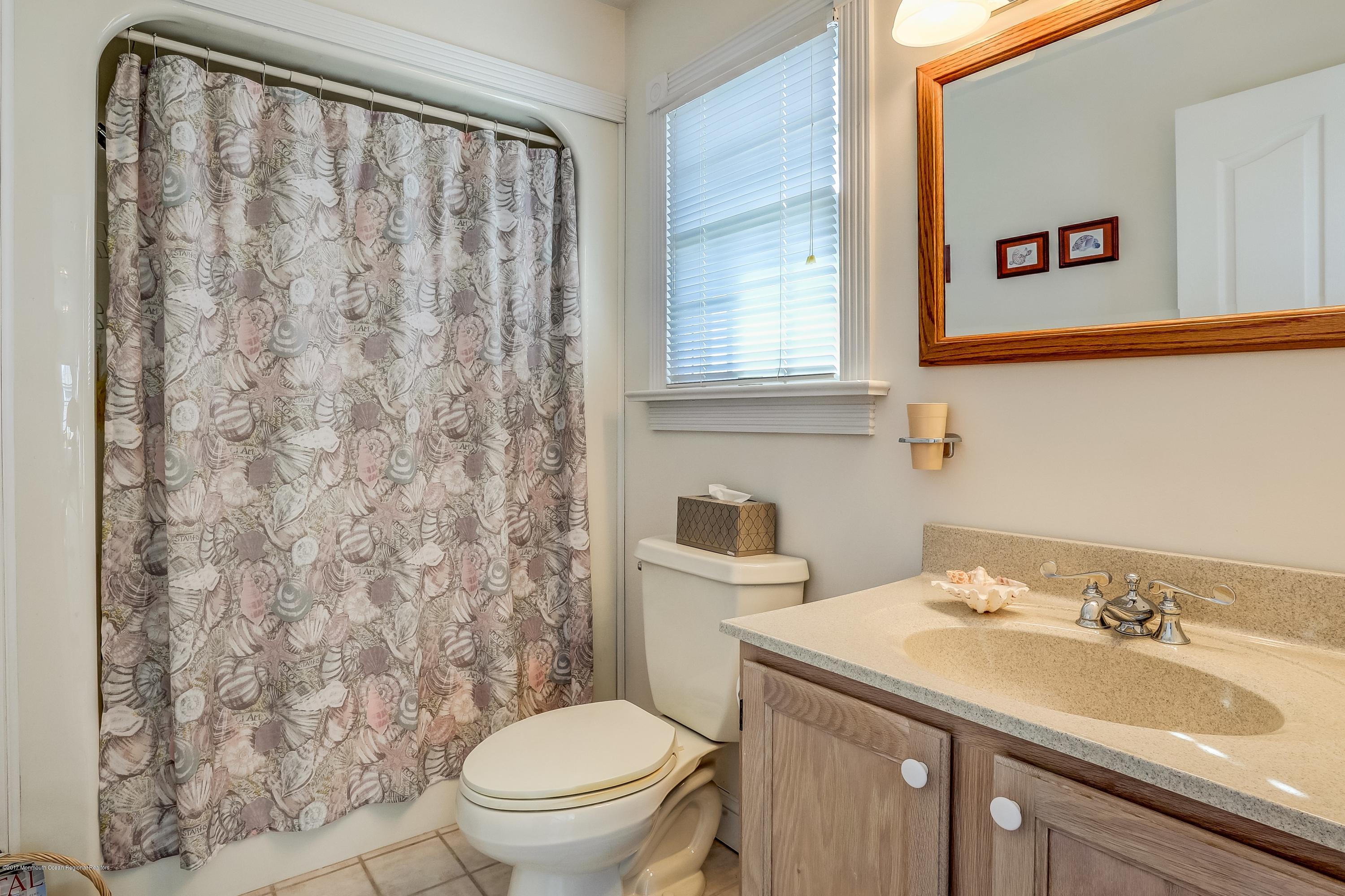 107 Clifton Road Barnegat, NJ 08005 - Photo 17 of 33 a bathroom with a sink toilet and a mirror