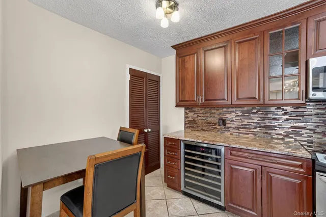 a kitchen with granite countertop a sink stove and refrigerator