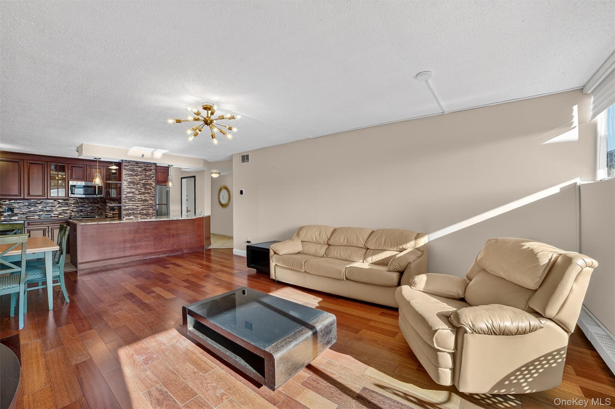 25 Rockledge Avenue, Unit 606 White Plains, NY 10601 - Photo 17 of 43 a living room with furniture and a chandelier