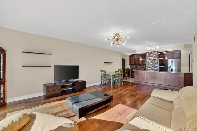 a open kitchen with stainless steel appliances granite countertop a stove and a refrigerator