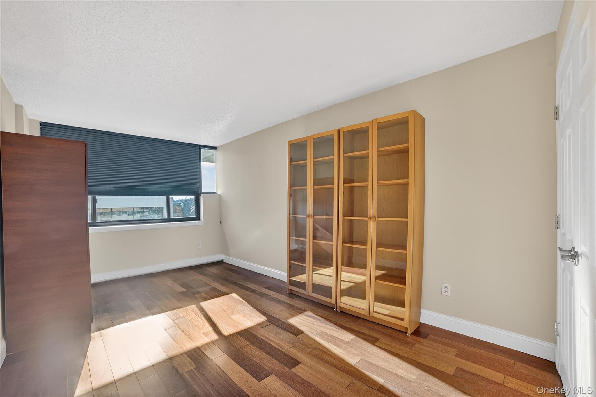 25 Rockledge Avenue, Unit 606 White Plains, NY 10601 - Photo 31 of 43 an empty room with wooden floor and windows