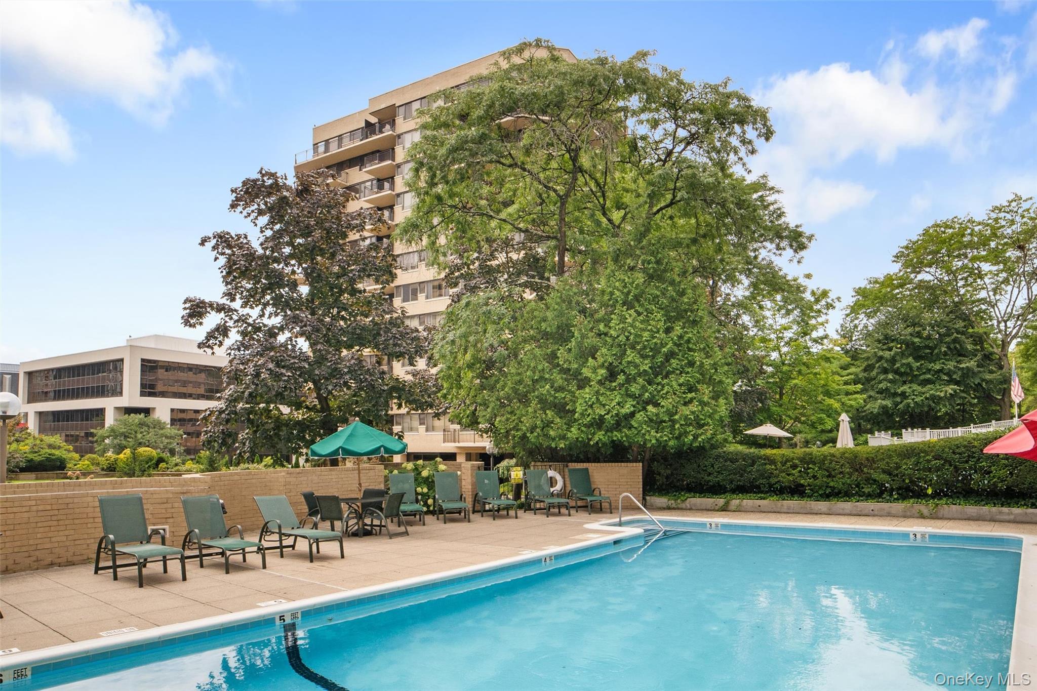 25 Rockledge Avenue, Unit 606 White Plains, NY 10601 - Photo 39 of 43 a view of a swimming pool with a patio and a garden