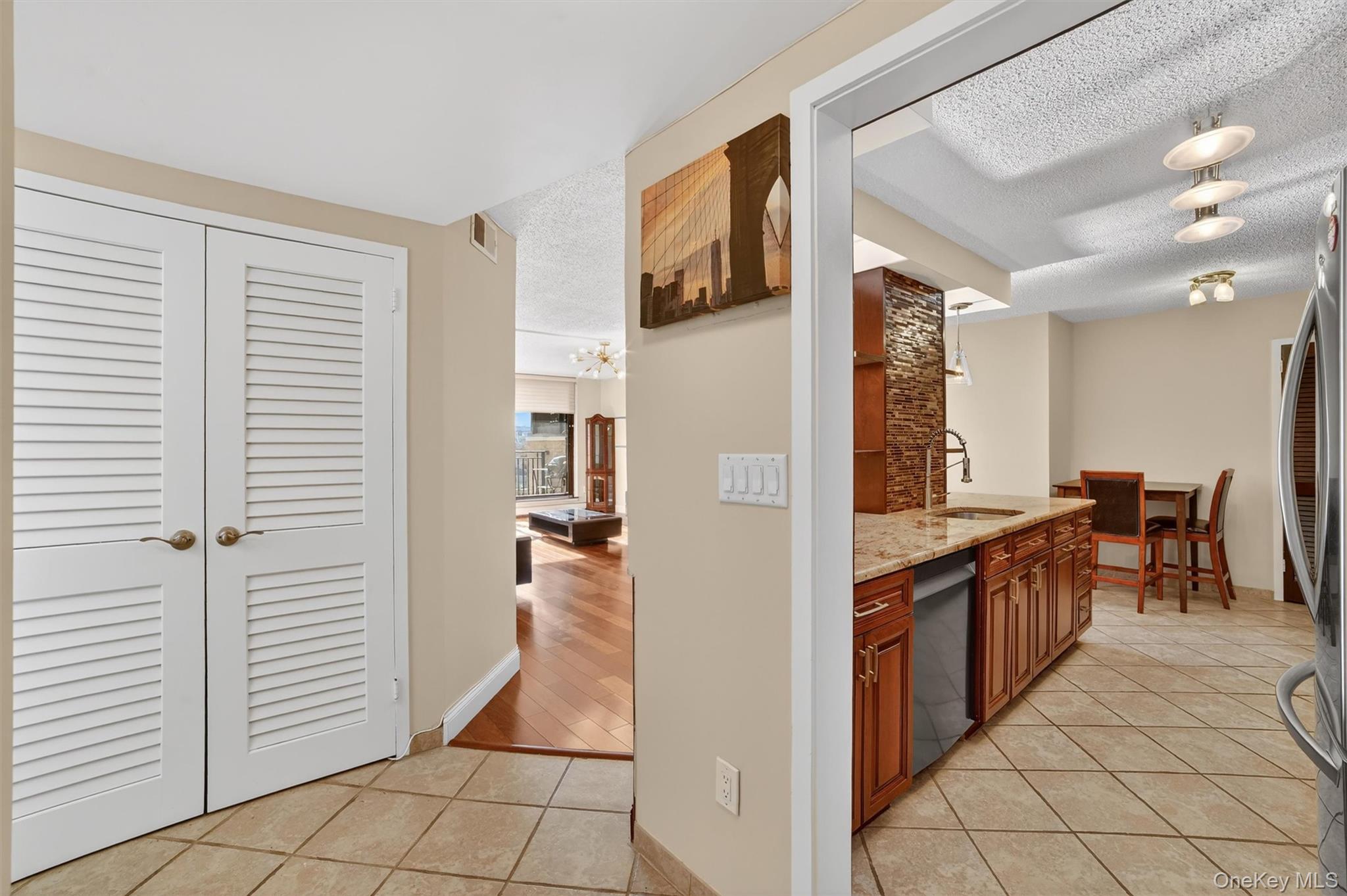 25 Rockledge Avenue, Unit 606 White Plains, NY 10601 - Photo 5 of 43 a kitchen with stainless steel appliances granite countertop a refrigerator and a sink