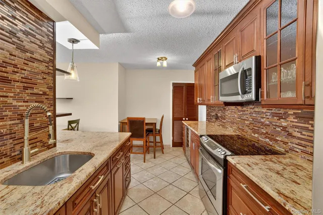a kitchen with stainless steel appliances granite countertop a stove and a sink