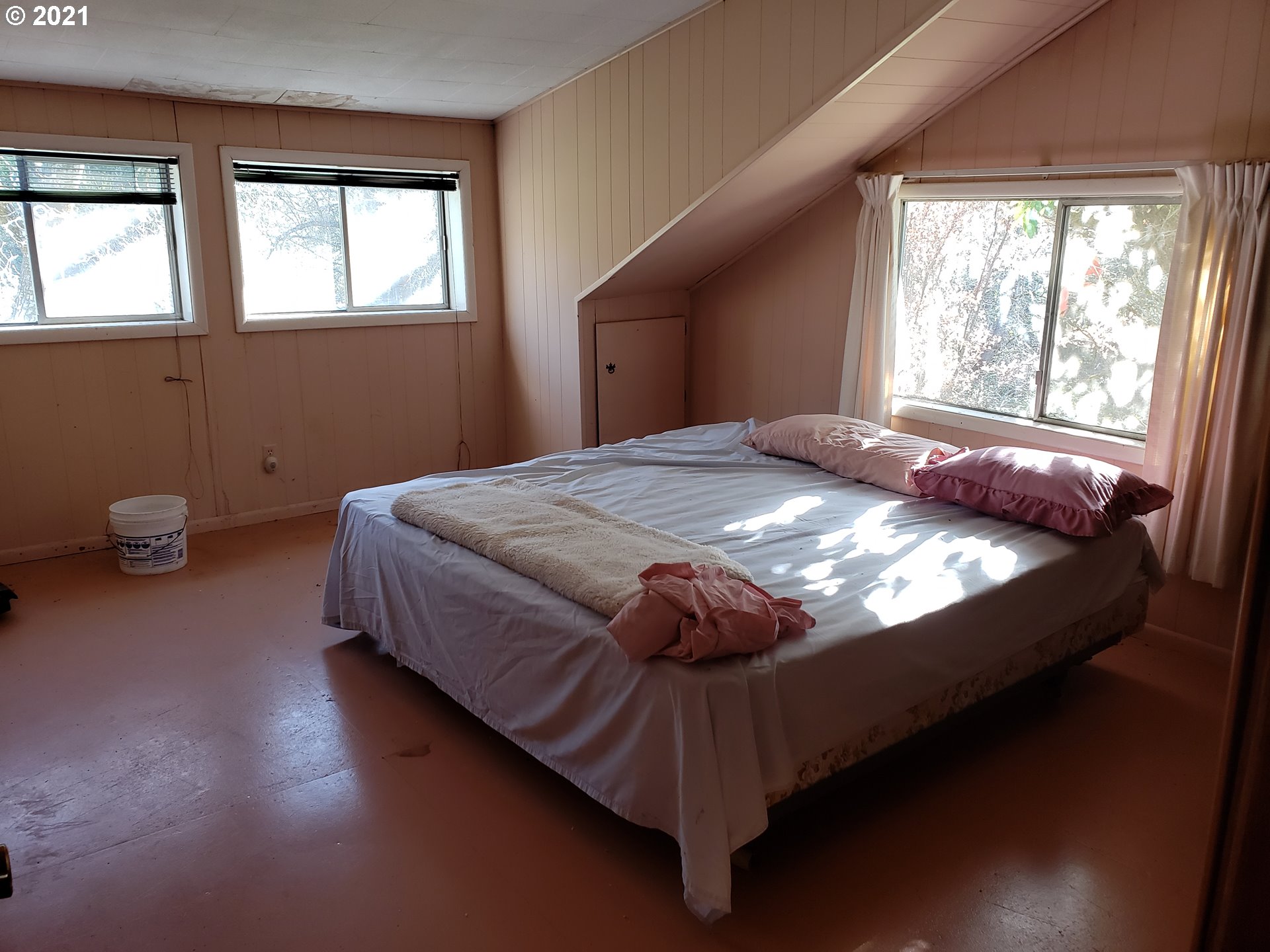 403 Meyer Lane Riddle, OR 97469 - Photo 24 of 25 a bed sitting in a bedroom next to a window
