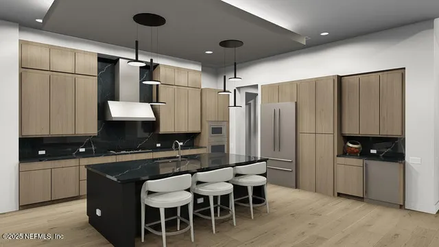 a kitchen with stainless steel appliances a sink stove and refrigerator