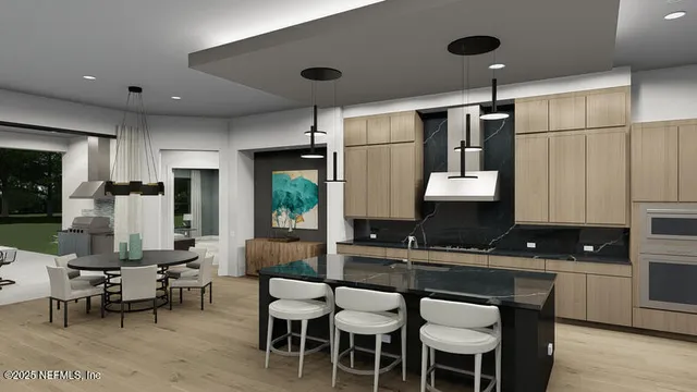 a kitchen with stainless steel appliances a sink a stove a refrigerator and cabinets