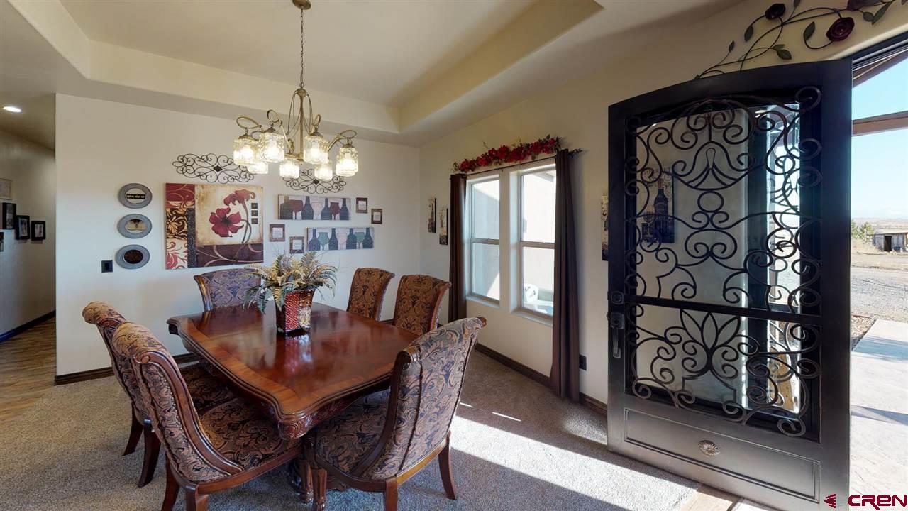 8370 2000th Road Austin, CO 81410 - Photo 12 of 35 a view of a dining room with furniture and chandelier