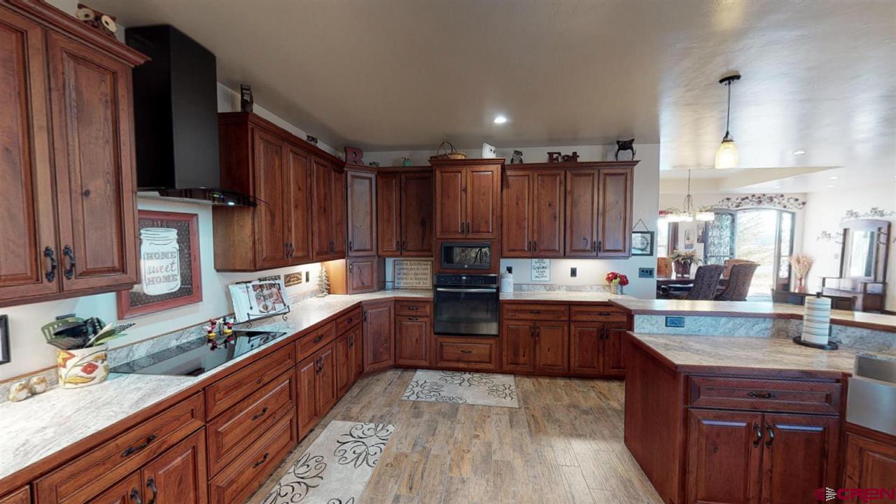 8370 2000th Road Austin, CO 81410 - Photo 13 of 35 a kitchen with wooden cabinets and a sink